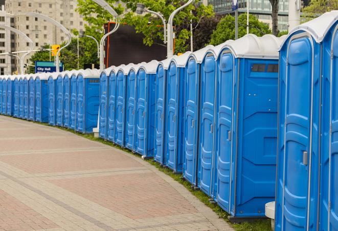 a row of portable restrooms at a fairground, offering visitors a clean and hassle-free experience in Hillside